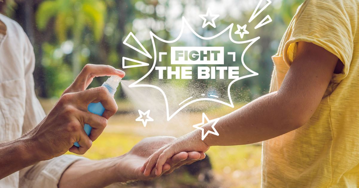 FIGHT_THE_BITE - lady spraying bug spray on a child