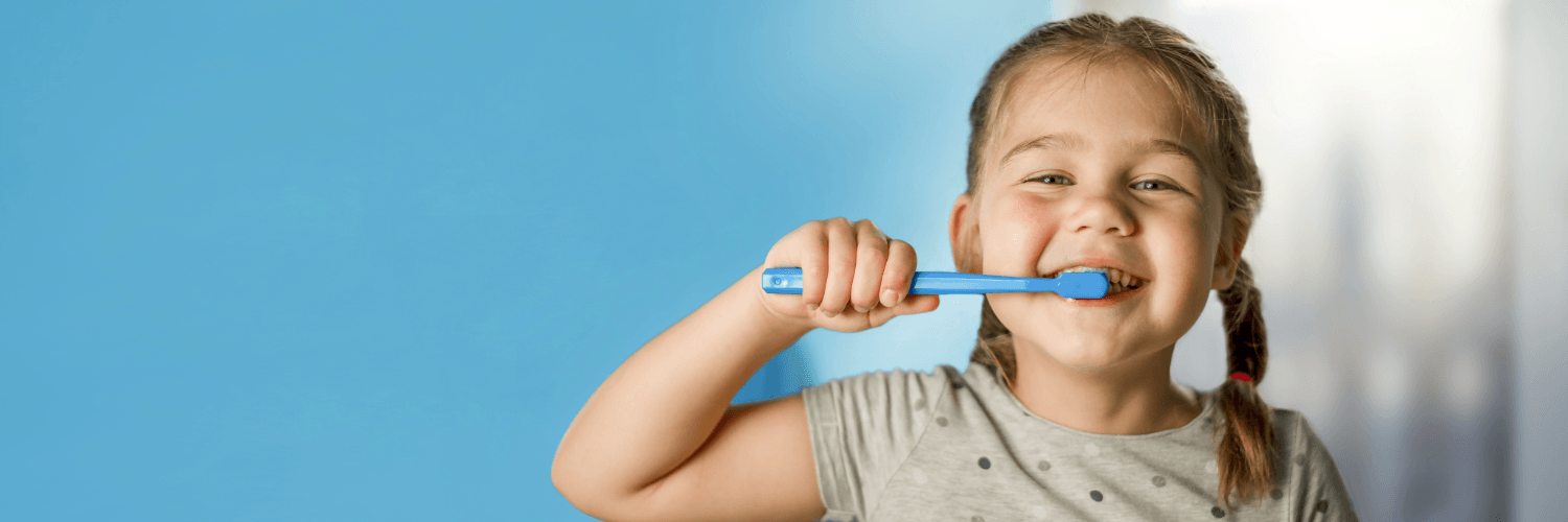 little girl brushing her teeth